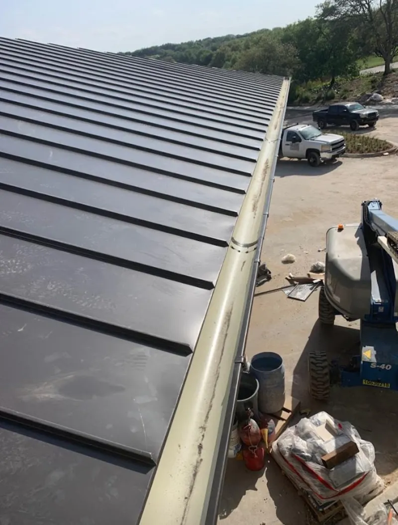 Standing seam panel and gutter detail on a metal roofing jobsite in Paducah